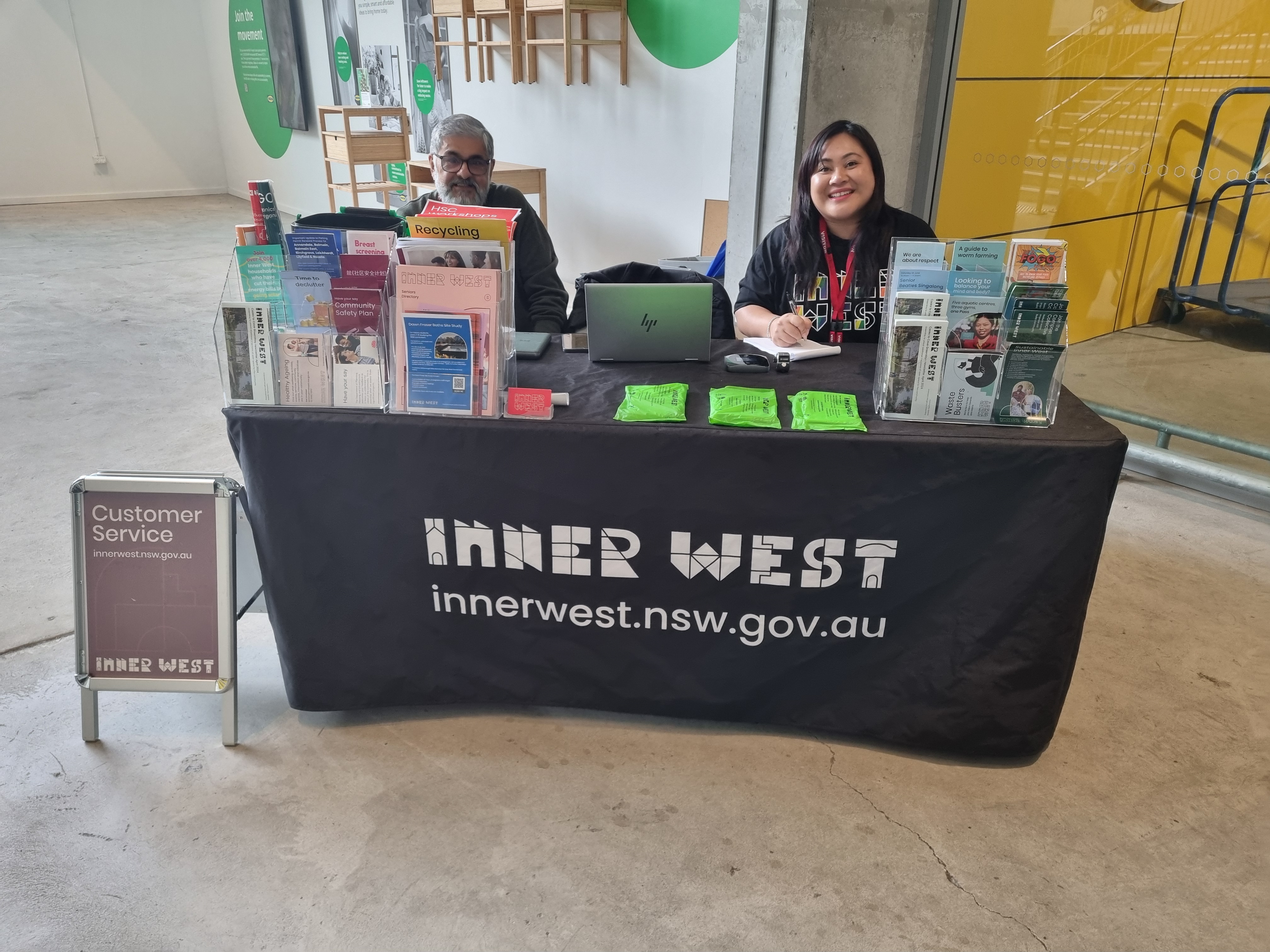 2 People sitting at a customer service stall